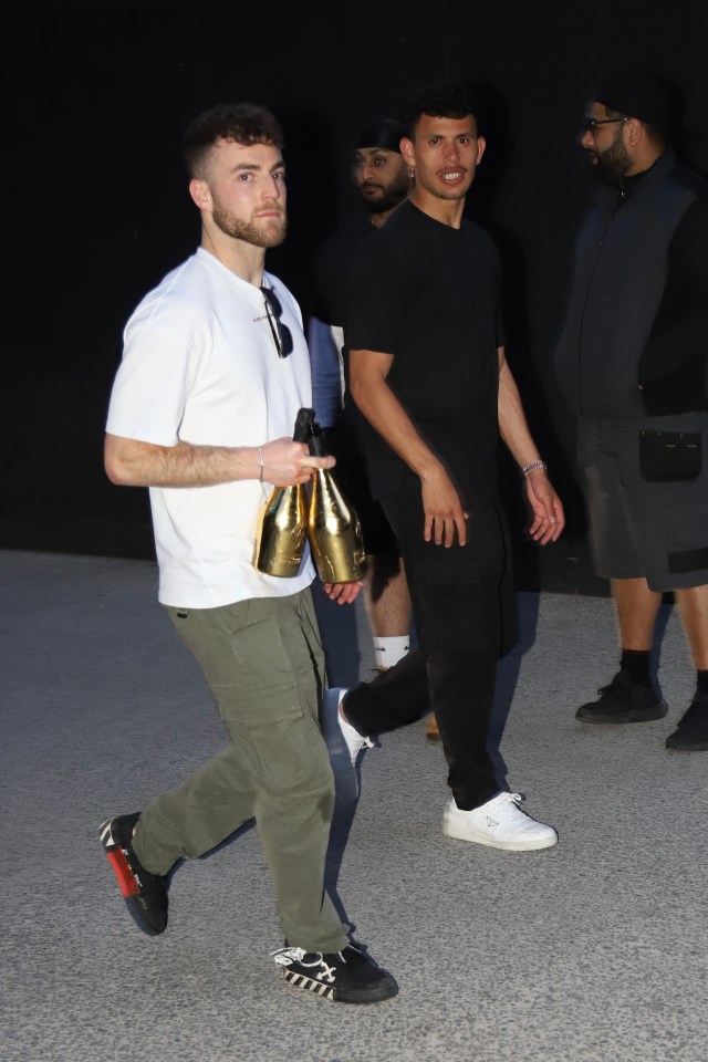 While Matheus Nunes, in black, was seen with a friend holding two £700 champagne bottles