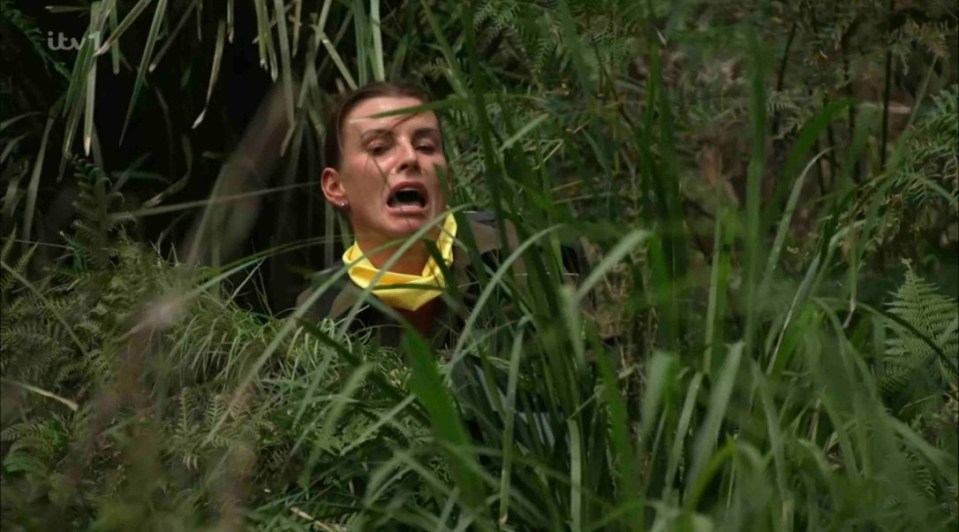 a woman in a yellow scarf is hiding in the tall grass