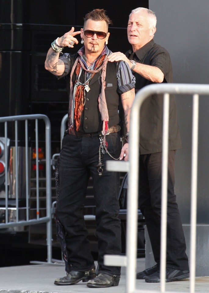 Johnny points at crowds who have gathered outside his gig in Pennsylvania 
