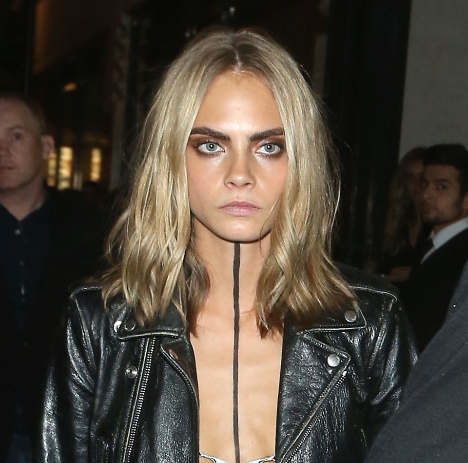 Cara Delevingne didn't look very happy as she left a London Fashion Week party