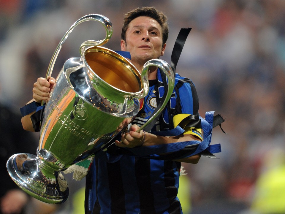 Inter Milan's Argentinian defender and captain Javier Aldemar Zanetti celebrates with the trophy after the UEFA Champions League final football match Inter Milan against Bayern Munich at the Santiago Bernabeu stadium in Madrid on May 22, 2010. Inter Milan won the Champions League with a 2-0 victory over Bayern Munich in the final at the Santiago Bernabeu. Argentine striker Diego Milito scored both goals for Jose Mourinho's team who completed a treble of trophies this season. AFP PHOTO / CHRISTOPHE SIMON (Photo credit should read CHRISTOPHE SIMON/AFP/Getty Images)