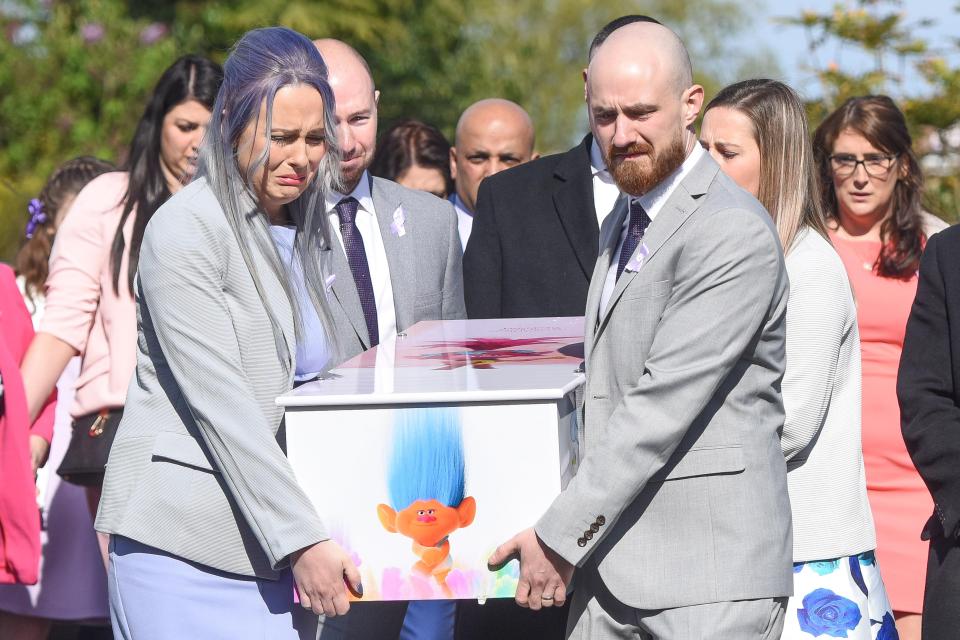The devastated parents of Violet-Grace Youens carry her tiny coffin into church as hundreds of mourners gathered for the four-year-old's funeral