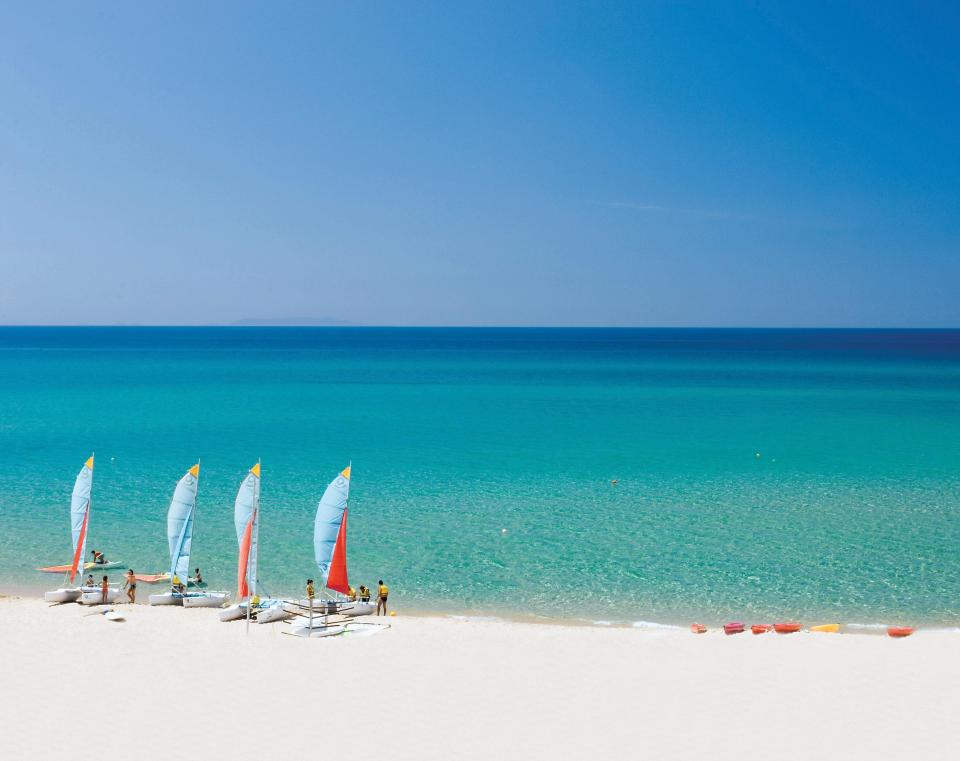  Picture perfect... Windsurfers on the white sands of Sardinia