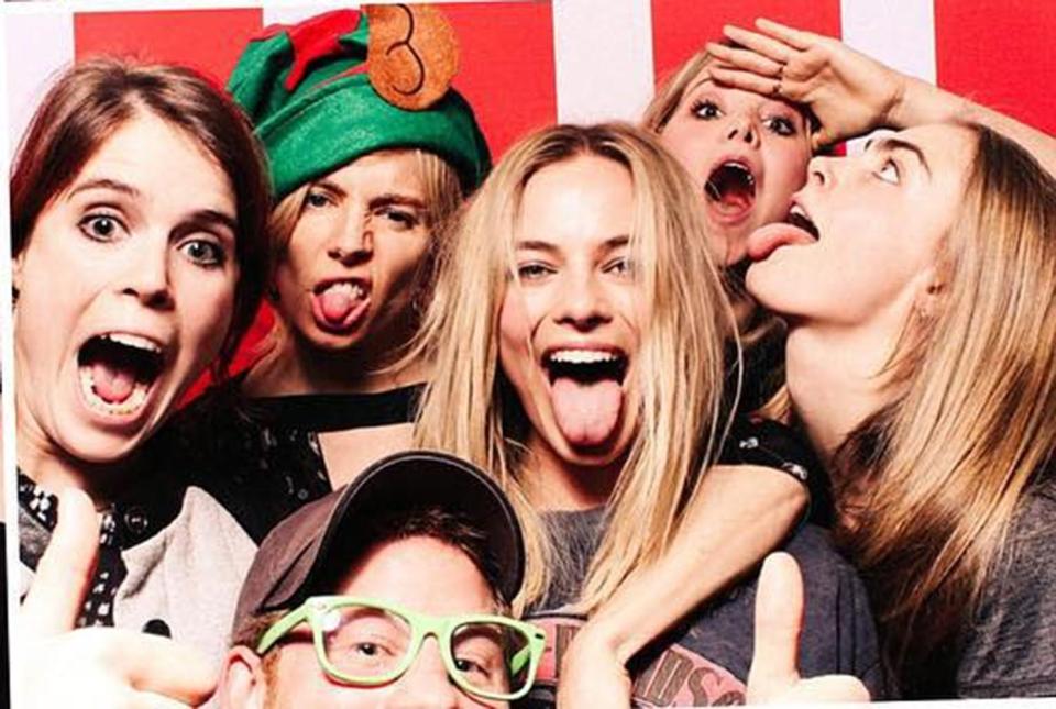 Margot in the centre with Prince Harry right underneath, and from left, Princess Eugenie, Sienna Miller, Poppy Jamie and Cara Delevingne