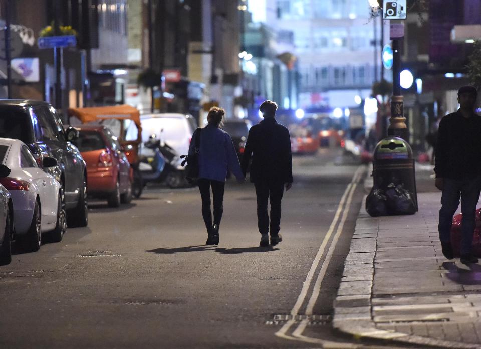  The couple held hands as they walked down the street