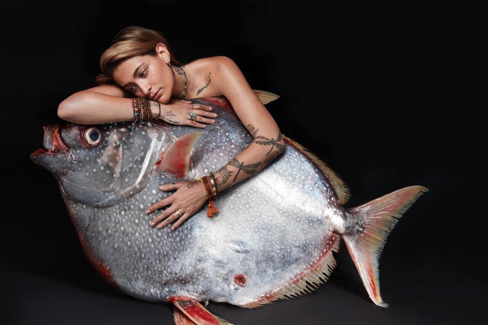 The late Michael Jackson's daughter, Paris, wraps her 'fishlove' arms around a big Opah fish