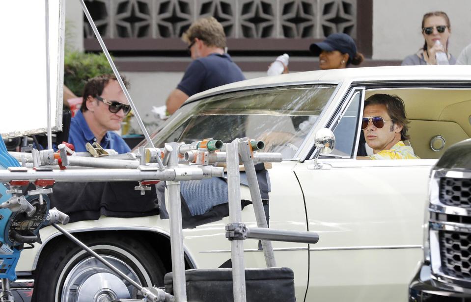 The actor, who plays the stunt double of Leonardo DiCaprio's character in the flick, filmed under the watchful eye of Tarantino himself (left)