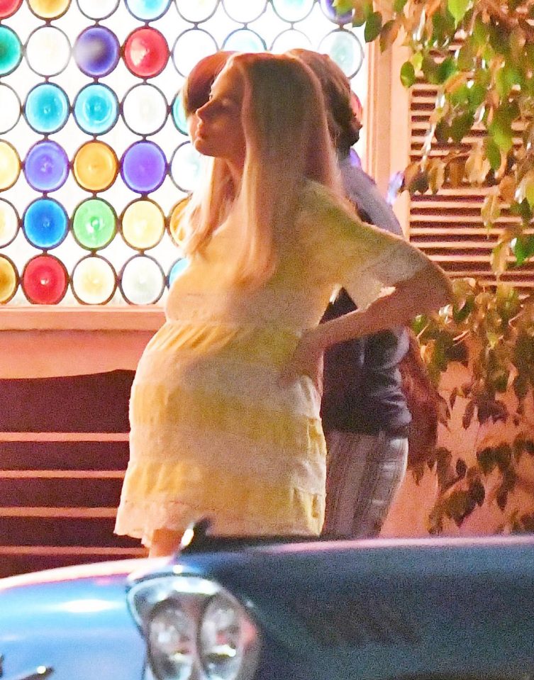  Margot looked relax despite the heavy suit as she watched her co-stars at work between takes