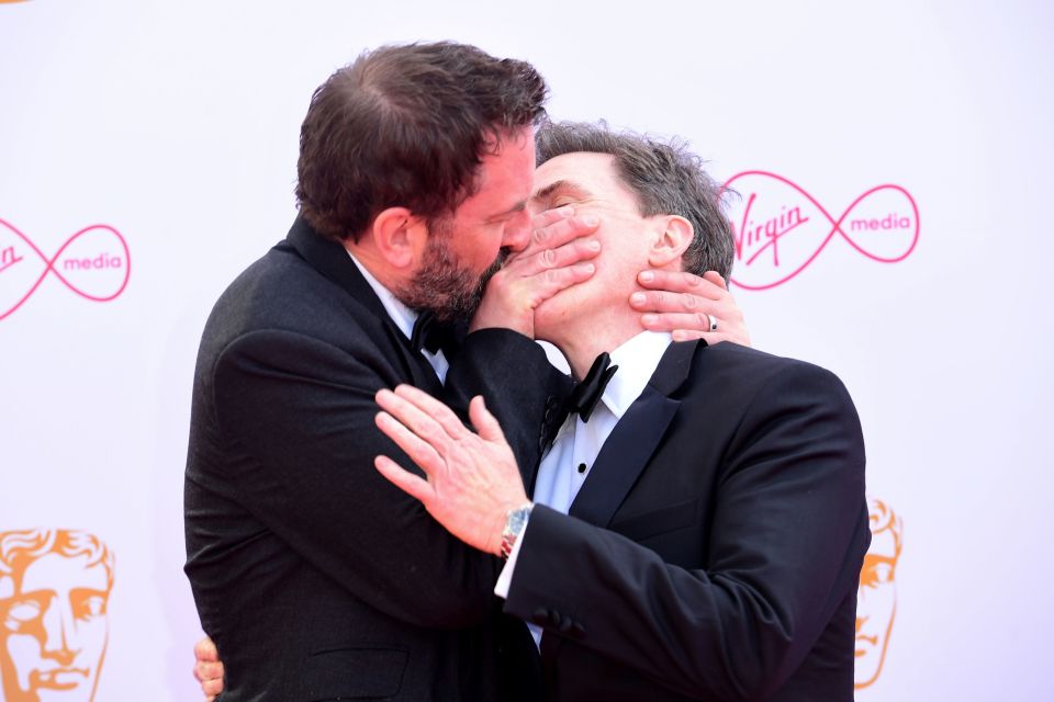  Lee shared a kiss with co-star Rob Brydon on the red carpet before his big win