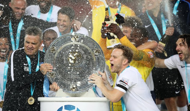 Robbie Williams and Olly Murs lift the trophy after winning the Soccer Aid for UNICEF 2018 match between England and The Rest of the World at Old Trafford on June 10, 2018