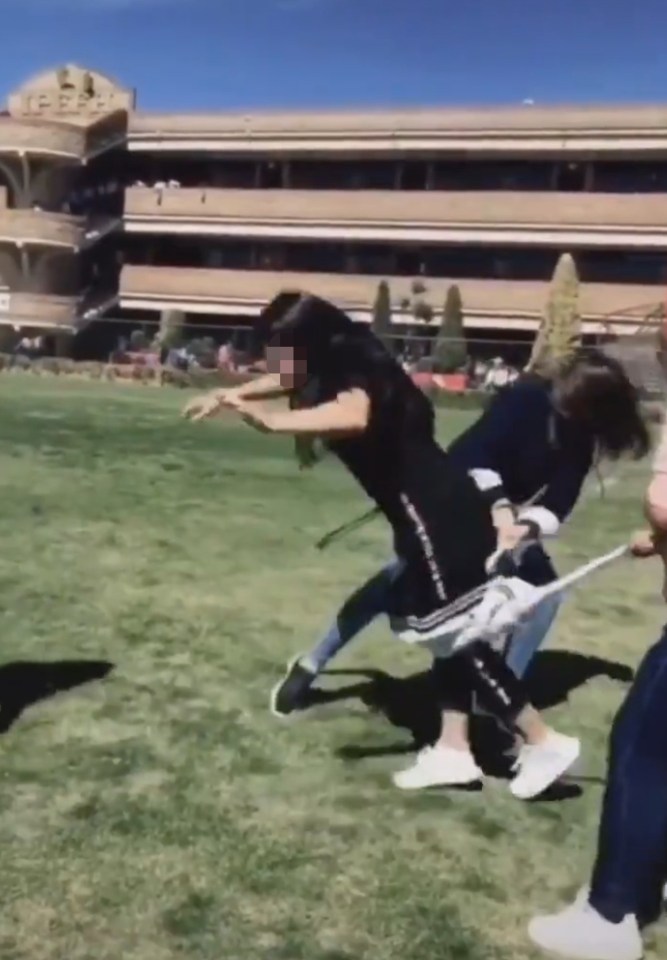  The girls use the arms of a sweater to trip up their classmate