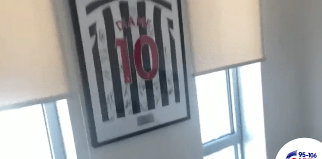  There's a framed Newcastle shirt on the wall