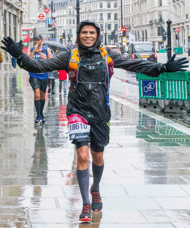 Marathon runner in London, arms outstretched.