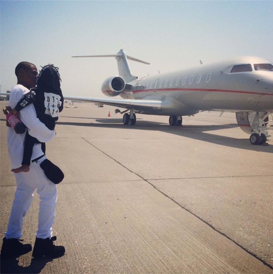 Jay Z carries a young Blue to their private plane