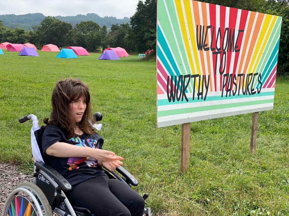 Our 19-year-old Elvi next to Worthy Pastures welcome sign. There is an accessible camping field