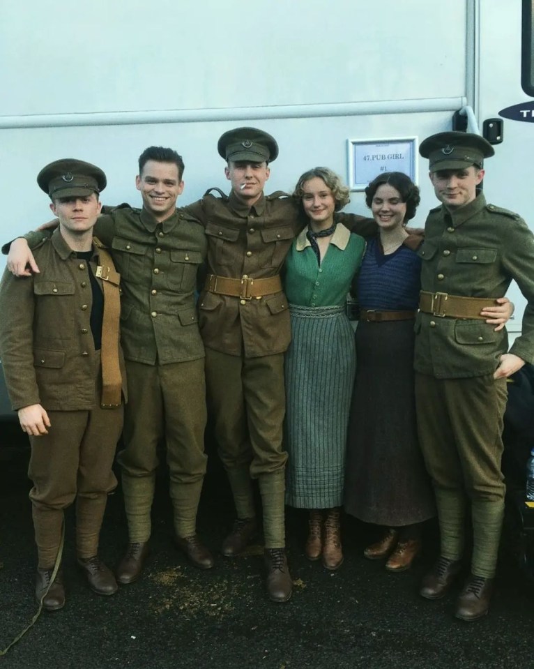 He beamed beside his co-stars behind the scenes