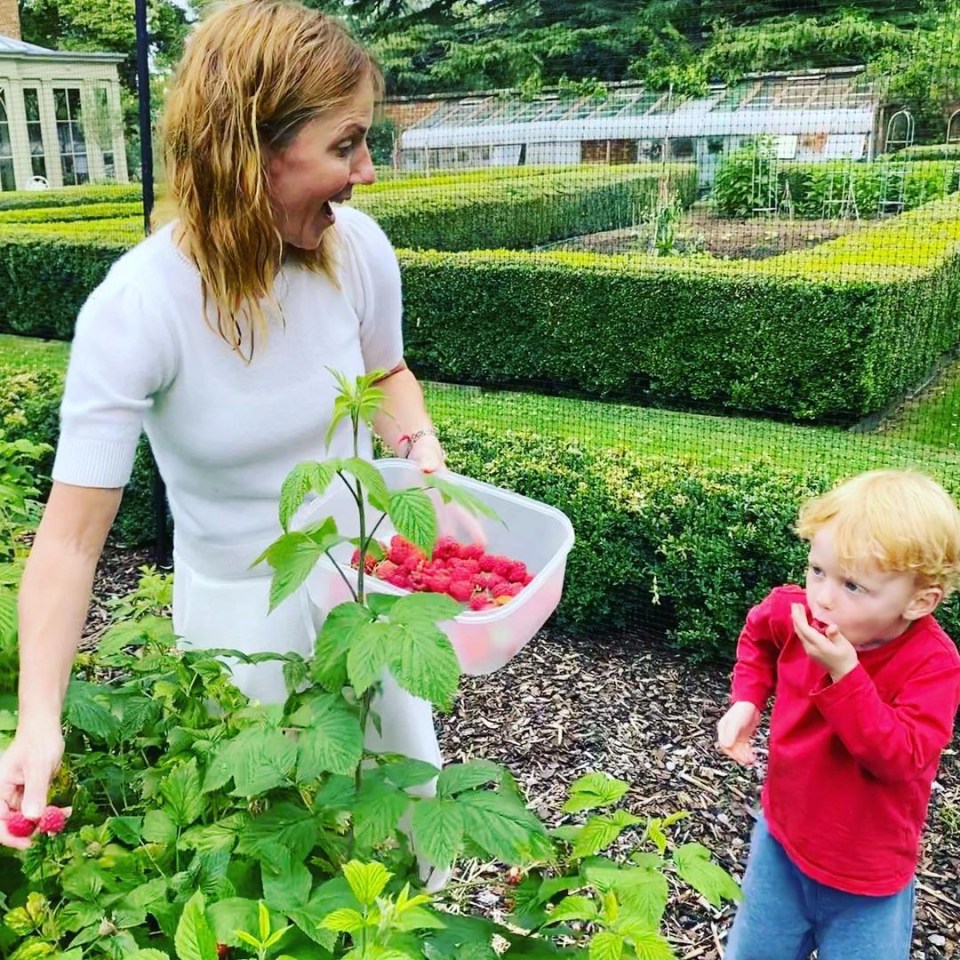 Geri picks raspberries with Montague in their lush garden