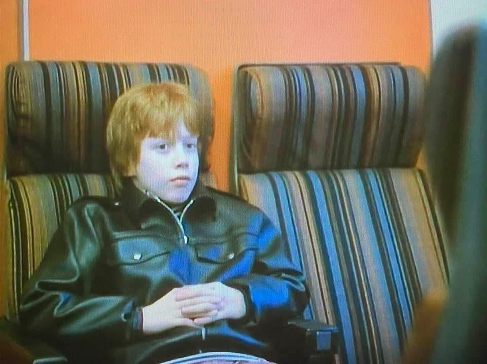 Luke 'Gonch' Gardner from Grange Hill sitting on a train.