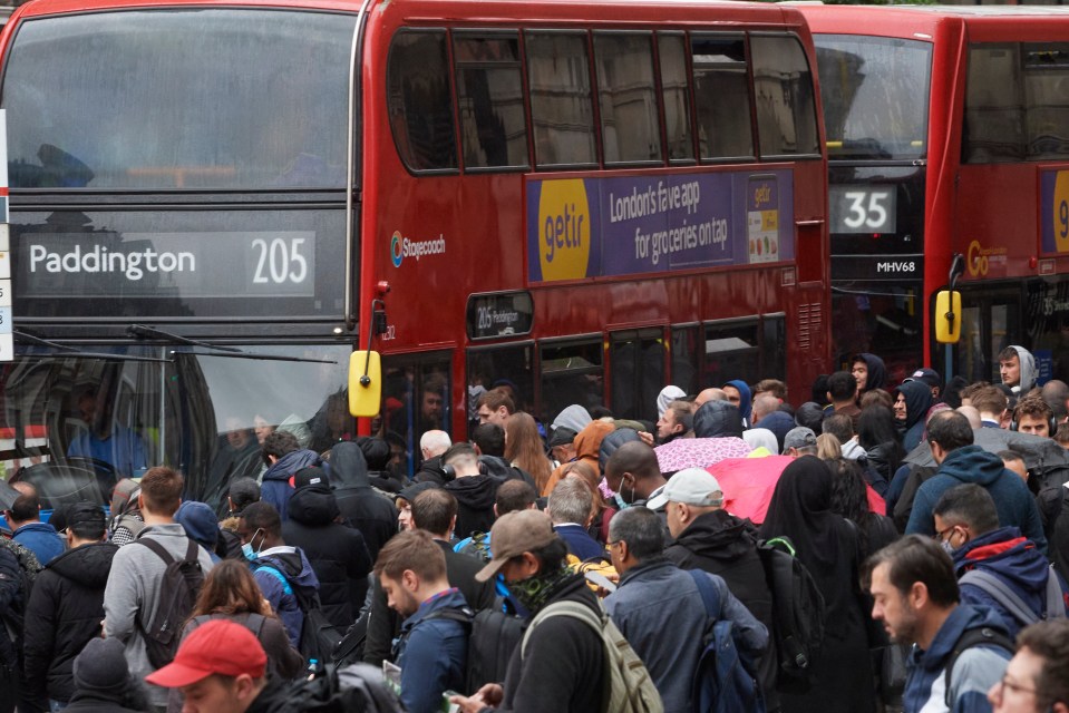 Commuters queue for busses at Liverpool Street Station