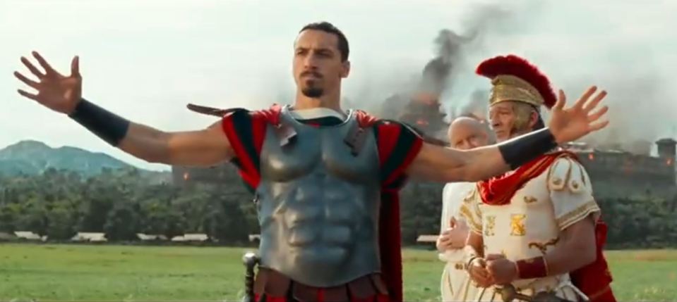 a man dressed as a roman soldier with his arms outstretched