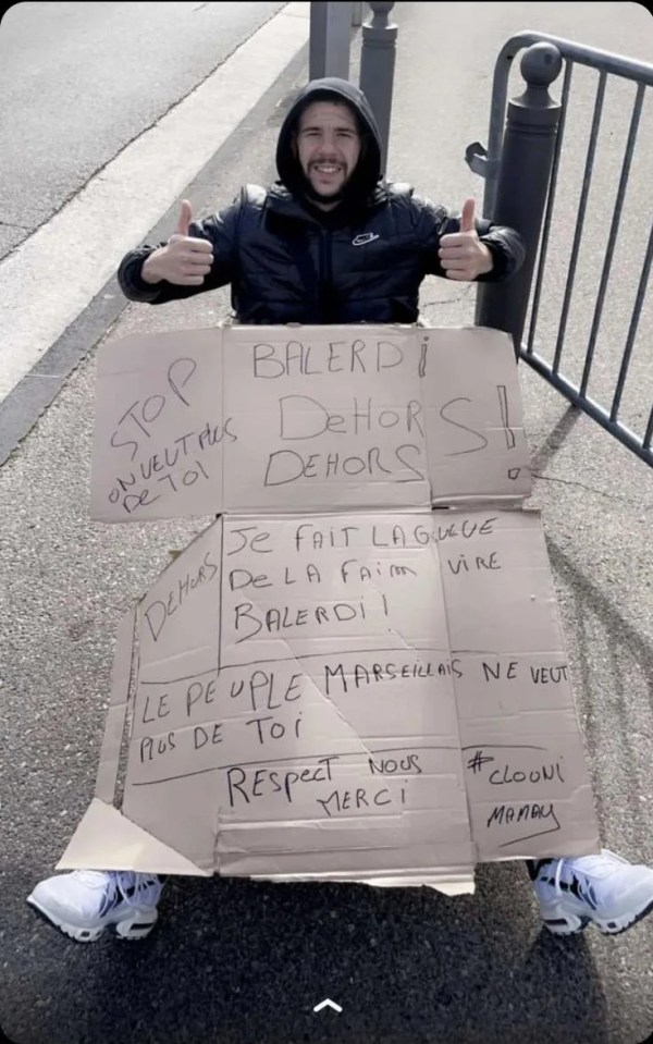 The sign translates as "the people of Marseille don't want you anymore, respect us, thank you."