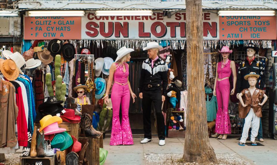 In the movie, Barbie jumps in her pink convertible with Ken to visit the real world and speak to the troubled person who is playing with her