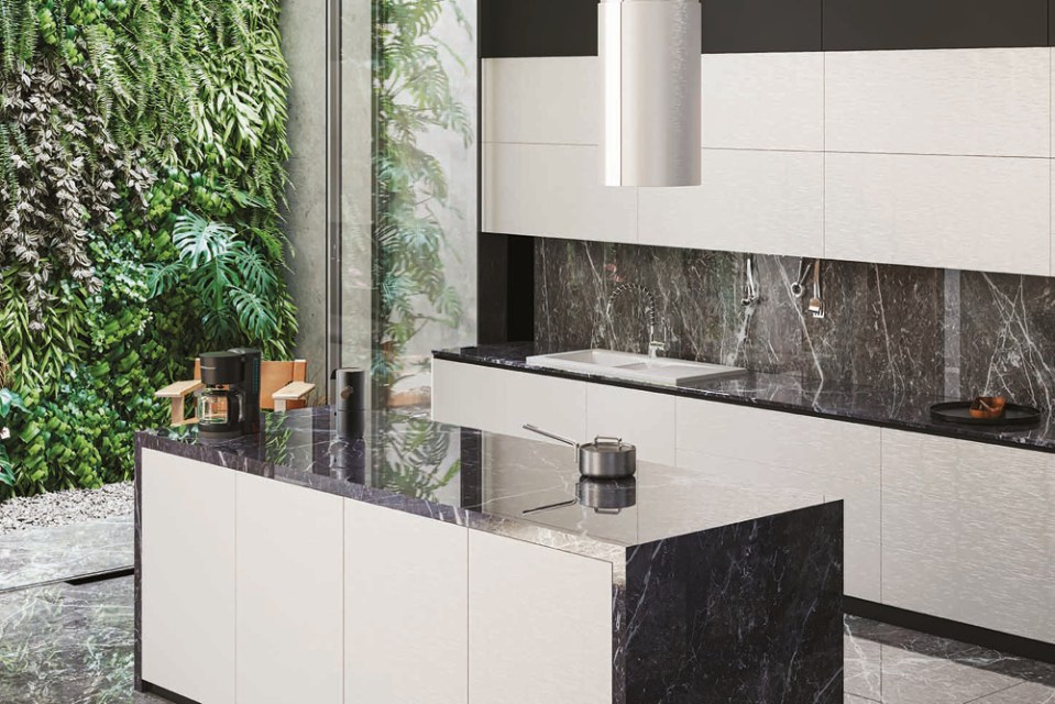 Modern kitchen island and countertops with dark marble.