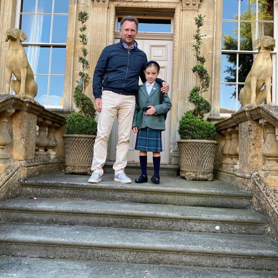 Christian standing on the steps of his luxurious home with daughter Olivia