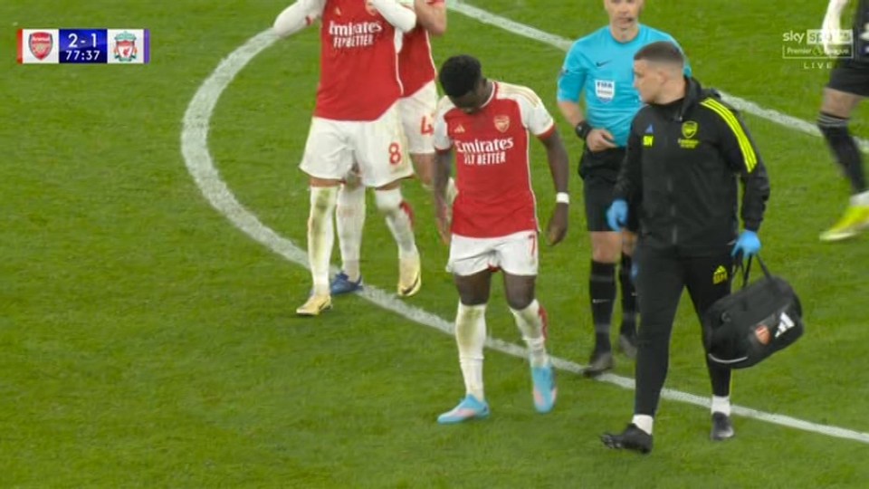 Saka received treatment before limping off at the Emirates Stadium