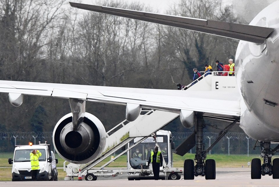 Some of the 83 Brits and 27 foreign nationals disembark a plane RAF Brize Norton after flying in from Wuhan