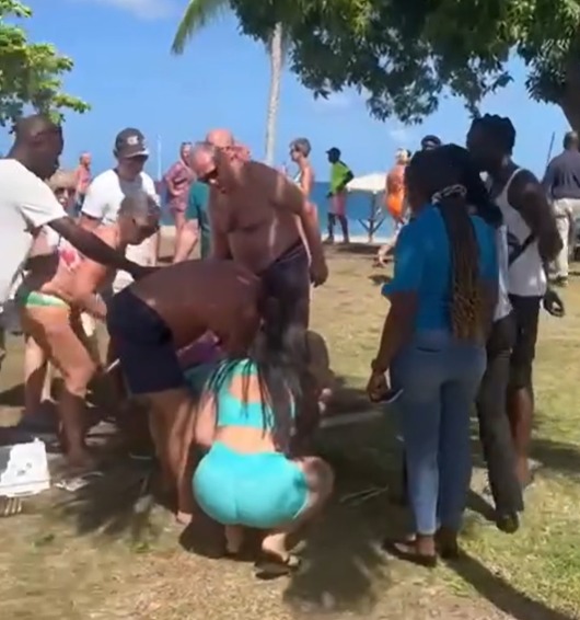 A crowd gathers around the victim in the moments after the attack