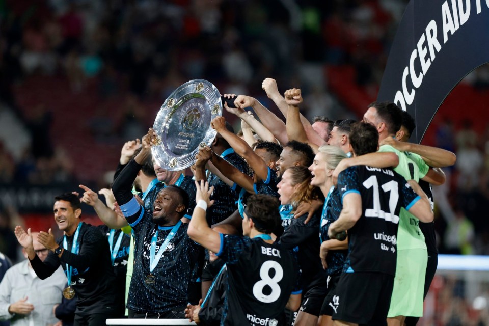 Soccer Football - Soccer Aid 2023 - Old Trafford, Manchester, Britain - June 11, 2023 Usain Bolt and teammates celebrate with the trophy after winning the Soccer Aid 2023 Action Images via Reuters/Jason Cairnduff