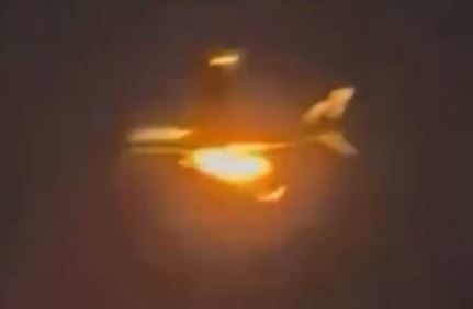 a plane is flying through the air with a bright light behind it