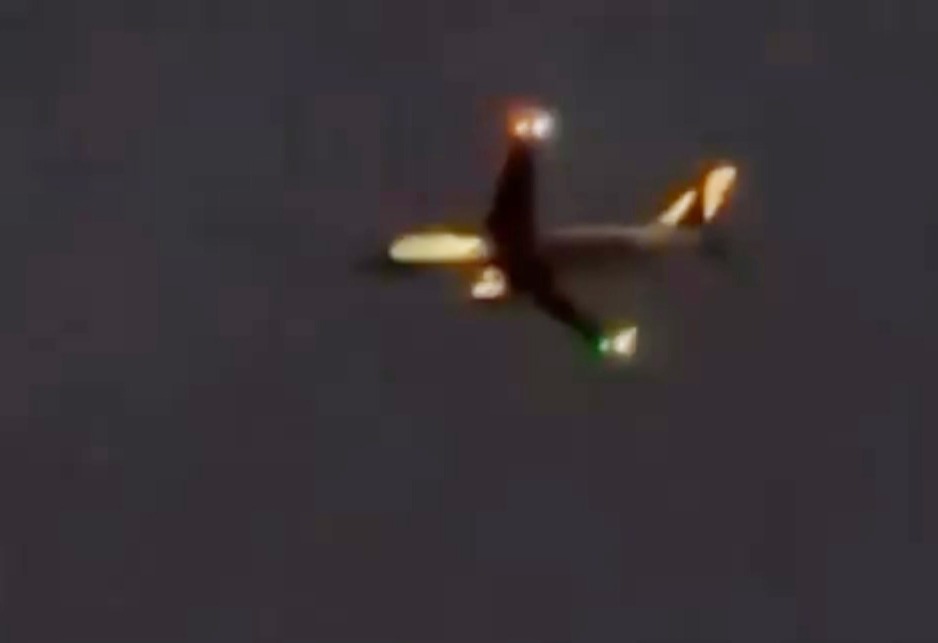 a plane is flying through a dark sky at night .