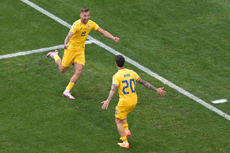 Romania's forward #19 Denis Dragus celebrates scoring his team's third goal with Romania's forward #20 Dennis Man during the UEFA Euro 2024 Group E football match between Romania and Ukraine at the Munich Football Arena in Munich on June 17, 2024. (Photo by DAMIEN MEYER / AFP) (Photo by DAMIEN MEYER/AFP via Getty Images)