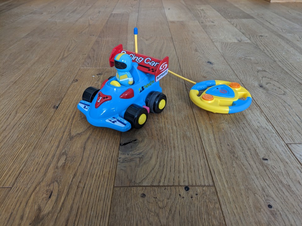 Toy remote control racing car with astronaut driver.