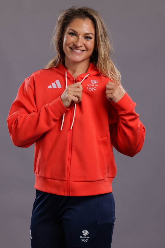 a woman is wearing a red adidas hoodie