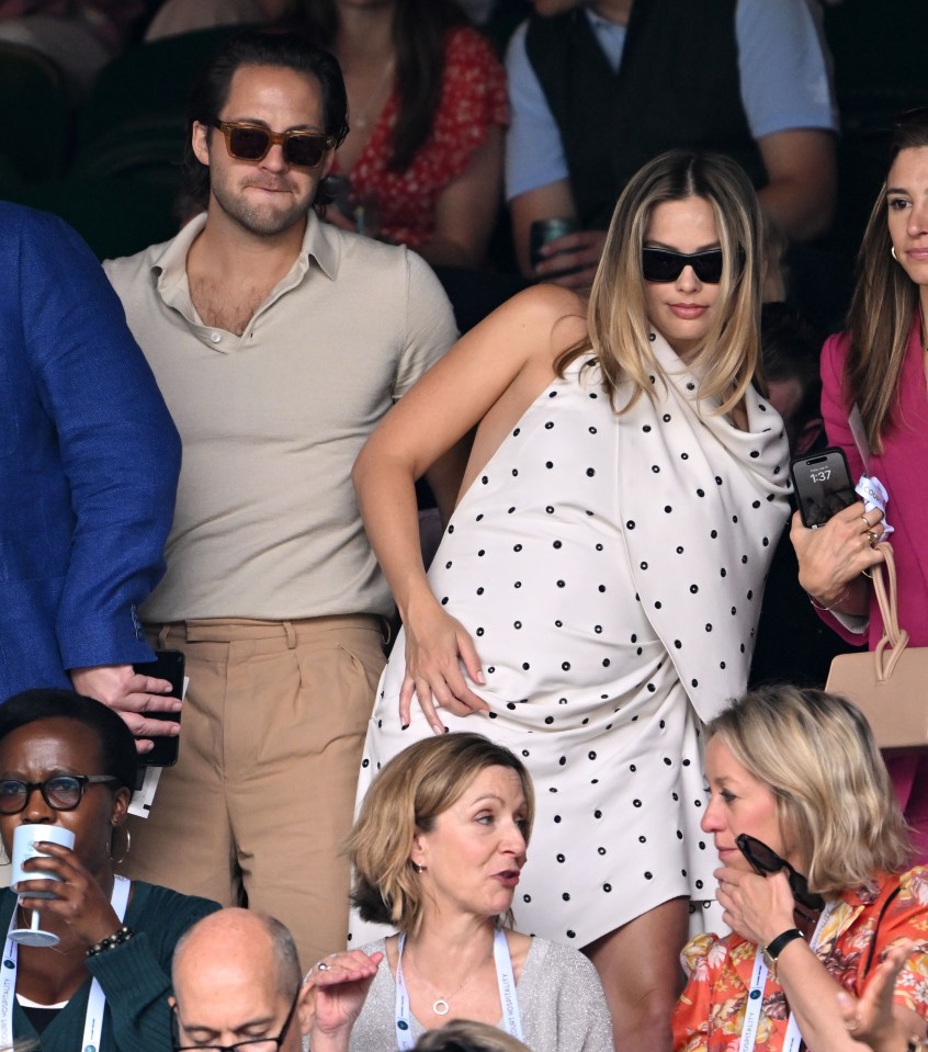 Margot Robbie looked radiant as she showed off her growing baby bump today