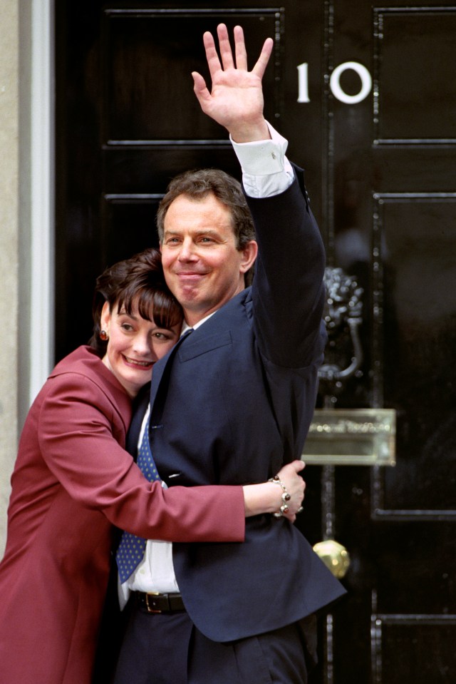 Former PM Tony Blair and wife Cherie embrace in Downing Street after Labour's victory in 1997