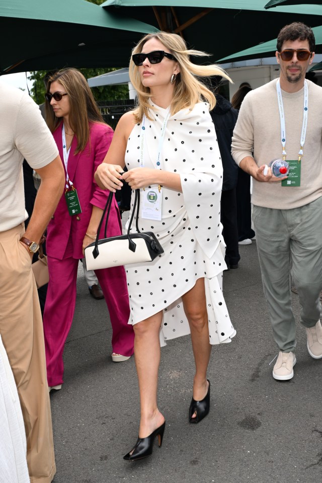 Margot was seen strolling through the VIP section wearing a hospitality lanyard