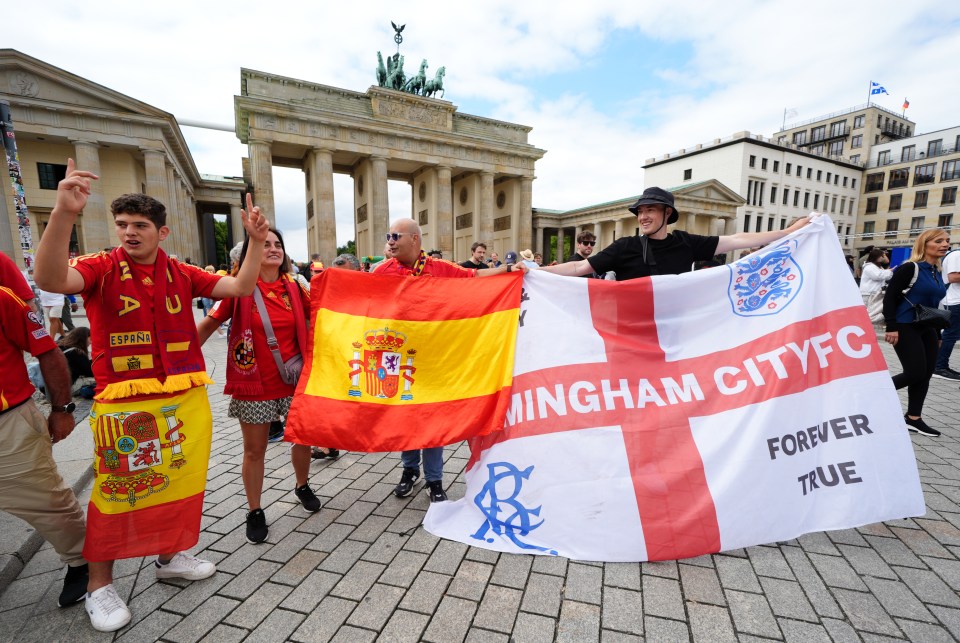 a group of people holding flags including one that says mingham city fc