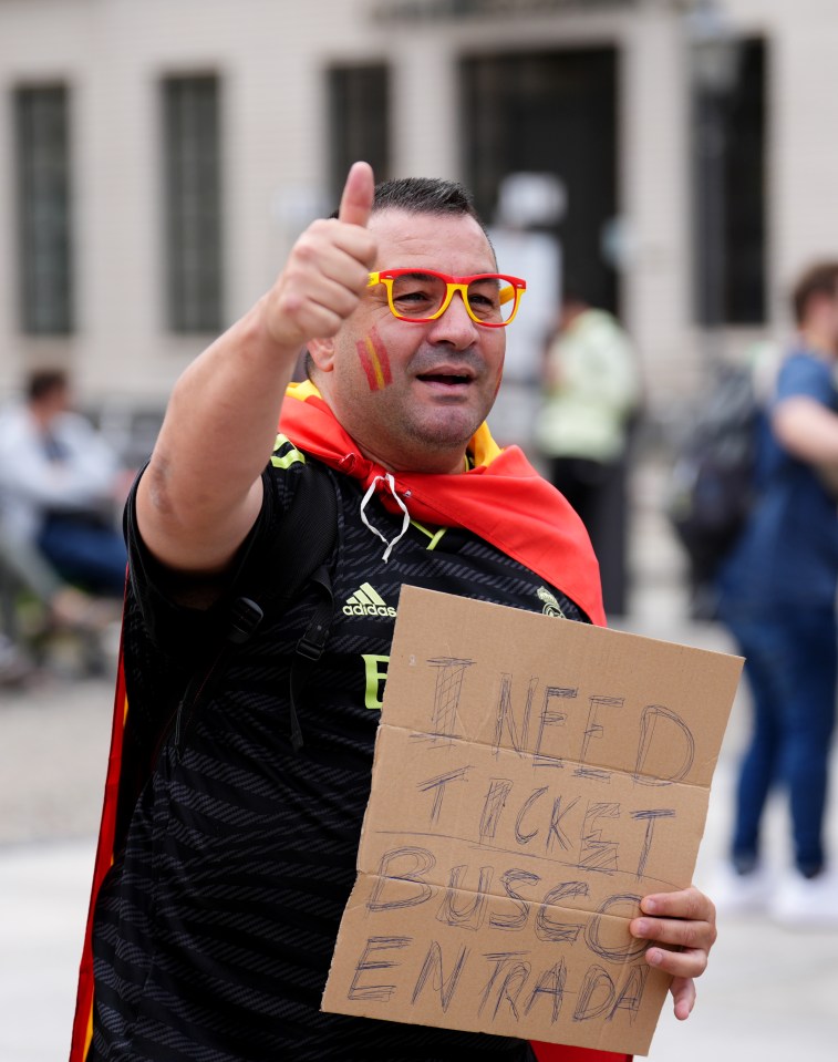 a man holding a sign that says " i need ticket busso entrada "