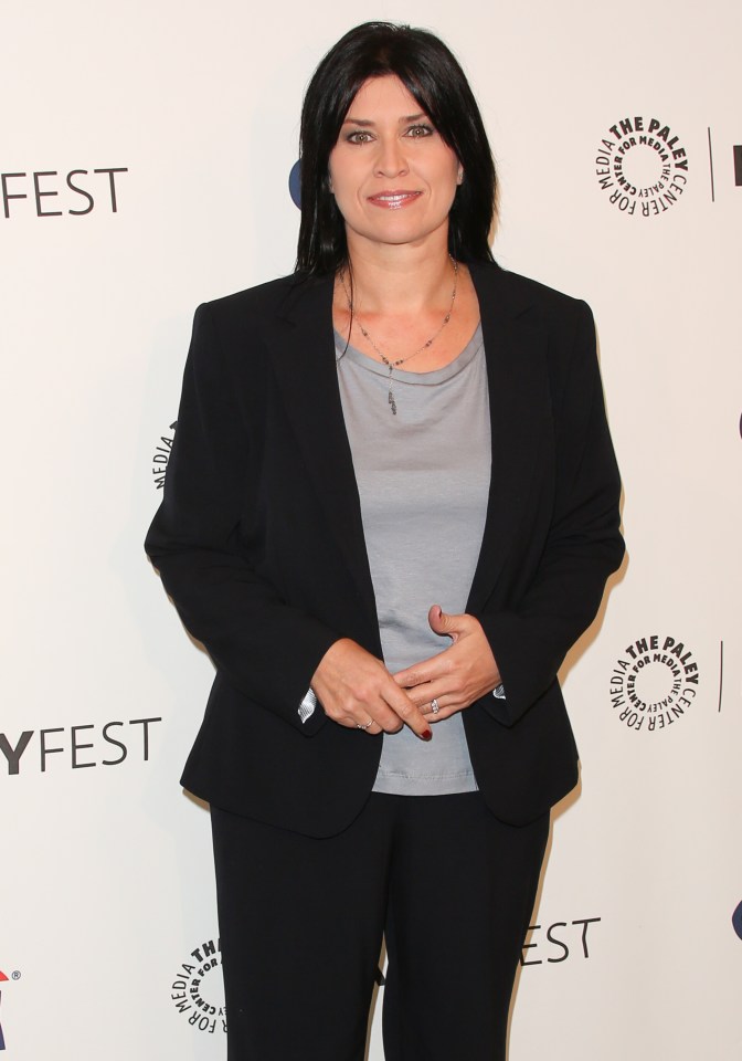 a woman stands in front of a sign that says fest