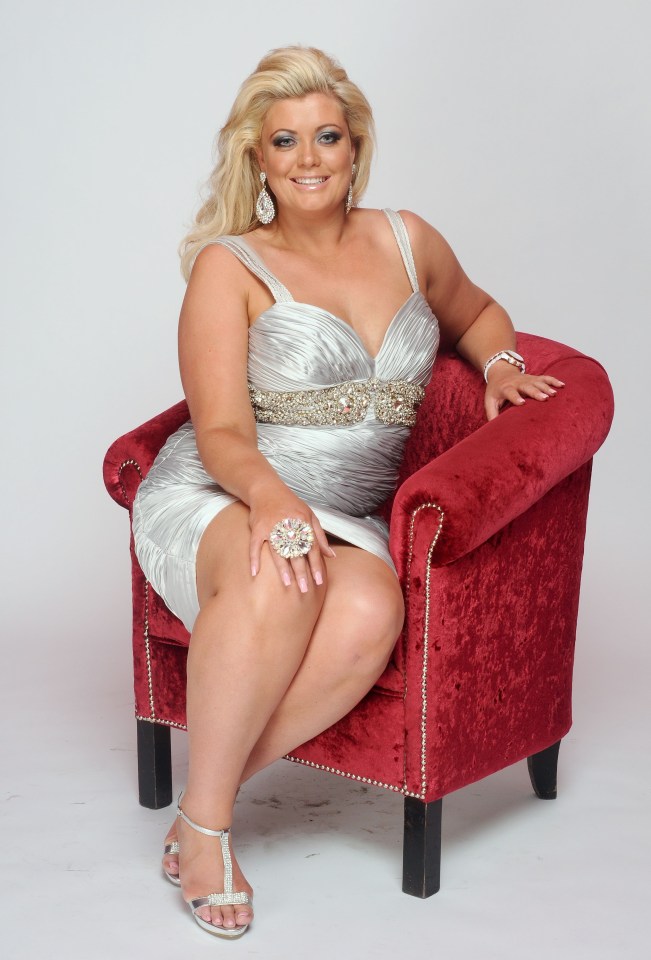 a woman in a silver dress is sitting in a red chair