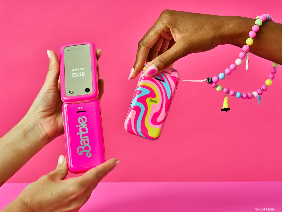 a pink flip phone with the word barbie on it