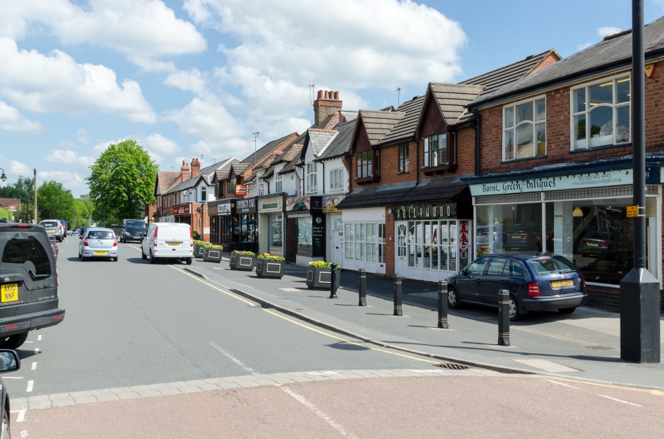 a row of shops on a street including a store that says ' tommy crofton ' on it
