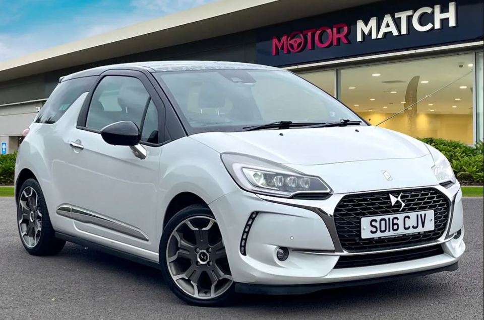 a white car is parked in front of a motor match store