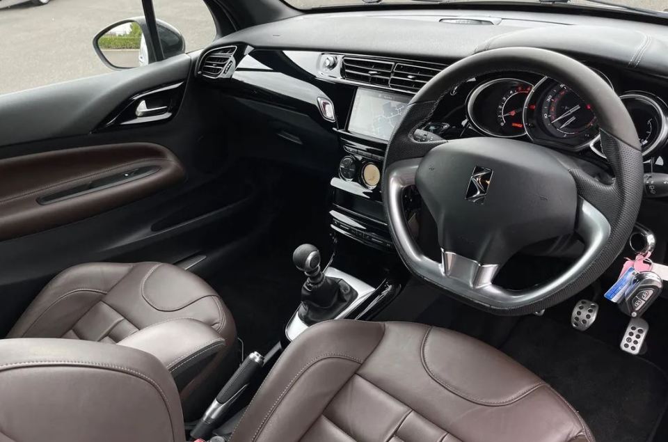 the interior of a car with a steering wheel and dashboard