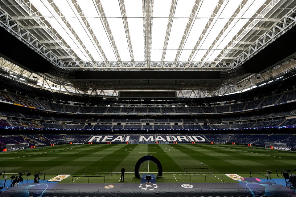 an empty soccer stadium with the word real madrid on the field