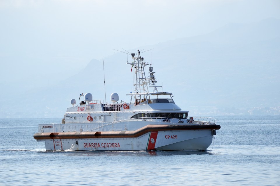 a boat with guardia costiera on the side of it